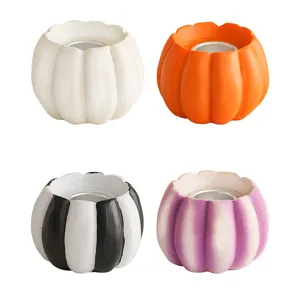 Resin pumpkin candle holder detail view, festive autumn table decor, set of four colors.