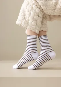 Close-up detail of striped cotton mid-tube socks, featuring soft fabric and comfortable fit.