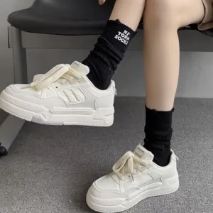 Embroidered high socks detail view, showing the unique letter design and thick cotton knit texture.