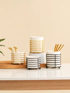 Ceramic tableware storage container set with metal frame for kitchen desktop organization.