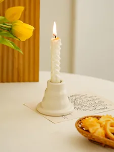 Minimalist ceramic candle holder with spiral candle detail for home decor and desktop.