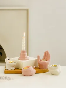 Cute ceramic candle holder set featuring ghost, apple, and hand shapes for cozy desktop decor.