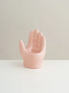 Pink ceramic hand shaped candle holder detail, cute home desktop decor ornament piece.