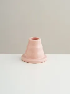Close-up detail of the pink ceramic candle holder, minimalist desk decor ornament.