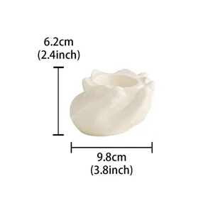 Ceramic candle holder detailed view, cute hand shaped design for home desktop decoration.