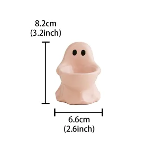 Close-up view of the cute pink ceramic ghost candle holder showcasing its smooth texture.