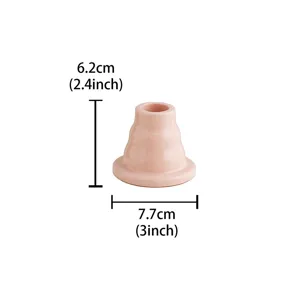 Close up of pink ceramic candle holder detail view, cute minimalist table decor piece.