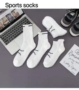 Nahaufnahme von weissen Frotteesocken mit feiner Rippenstruktur im modernen Schreibtischambiente.