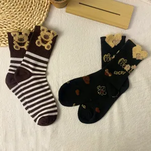 Cute autumn winter women mid-tube socks with fluffy teddy bear pattern and cozy striped style.