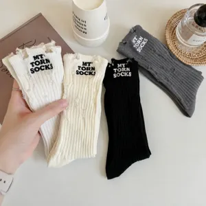 Distressed embroidered high tube socks for women, trendy chic casual cotton slouch socks.