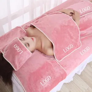 Coral velvet beauty salon towel set detail scene, soft pink fabric display on massage bed.