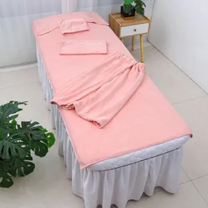 Coral fleece beauty salon bed cover detail, soft pink massage table linen set display.