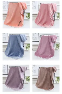 Microfiber thick towel detail view, soft absorbent fabric with neat piping edge and embroidery.