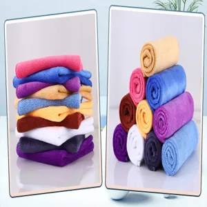 Detailed view of thick microfiber cleaning cloths in vibrant colors, folded and rolled.