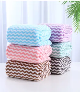 Detailed view of soft coral fleece bath towels with wave chevron pattern, highly absorbent and cozy.