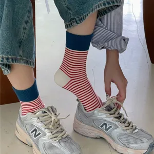 Striped mid-calf socks detail showing red and white stripes with blue ribbed cuffs.