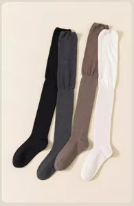 Close-up detail of knitted over-the-knee socks showing soft ribbed texture and four solid colors.