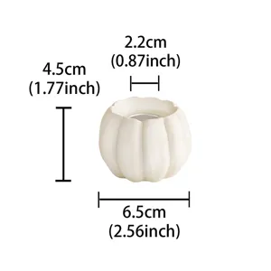 Resin pumpkin candle holder for Halloween decor, minimalist white tealight holder.