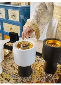 Close-up of Middle Eastern style concrete incense burner with gold interior for home decor.