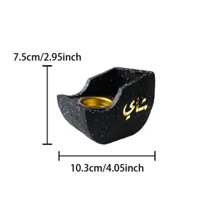 Detail view of creative resin boat-shaped incense burner with Arabic calligraphy and gold inner dish.