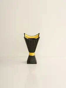 Close-up detail of black and gold Middle Eastern style incense burner table decor piece.