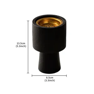 Close-up detail of the modern black and gold incense burner showing texture and dimension.