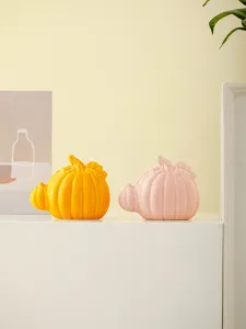 Ceramic pumpkin decor detail shot showing smooth yellow and pink glaze finish for modern desk.