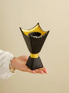 Detail view of the black and gold Middle Eastern style incense burner craft holding shape.