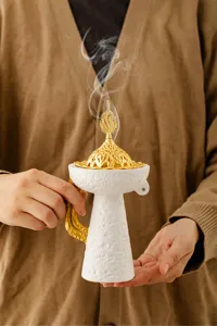Vista detallada de un quemador de incienso árabe con cúpula dorada en estilo oriental.