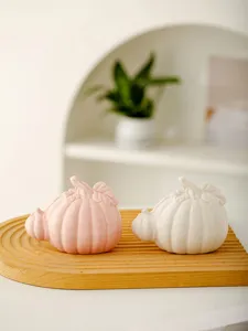 Close-up detail of ceramic pumpkin tabletop ornament, elegant home decor item for desk.