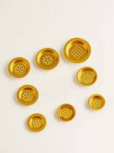 Gold hollow metal incense burner pads and hardware accessory detail display, set of pieces.