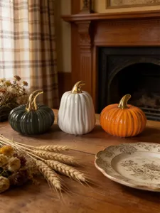 Set of 3 ceramic pumpkins with metallic gold stems, elegant autumn table decor for home.