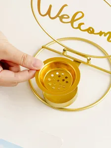 Gold iron incense burner detail view, hollowed tray accessory close up product shot.