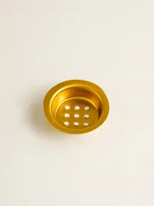 Gold metal incense burner mesh liner detail shot, hollow design hardware accessory closeup.