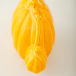 Minimalist ceramic pumpkin decor, glossy orange tabletop ornament for modern home office.
