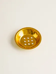 Gold metal incense burner pad detail showcasing perforated mesh holes and durable hardware craft design.