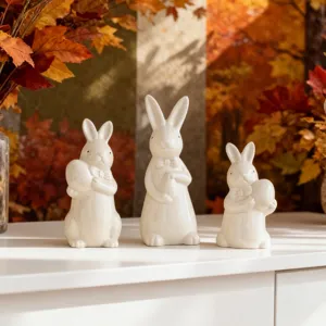 Easter ceramic rabbit figurines set of three cute bunnies with bow ties and eggs for home decor.