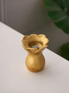 Resin flower candle holder detail showcasing textured gold petals and exquisite tabletop decor.