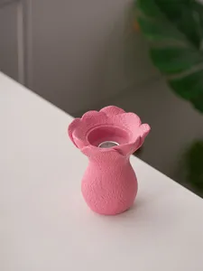 Pink resin flower candle holder detail shot, minimalist art home tabletop decoration craft.