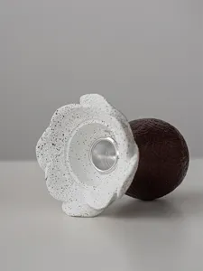 Close-up view of the minimalist resin flower candle holder detail, showcasing artistic speckled design.