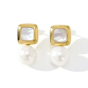 Detailed close-up of square shell gold drop earrings, elegant pearl and geometric design.