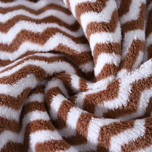 Soft coral fleece towel with brown chevron pattern, thick and absorbent for home and bathroom use.