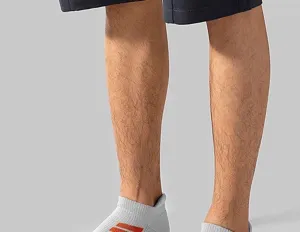 Close-up view of men's short sports terry socks in grey with orange stripe details.