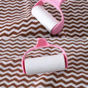 Lint roller for pet hair removal sticky cleaner tool with coral fleece fabric background main view.