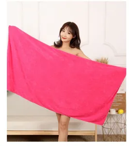 Microfiber towel detail view showing soft texture and bright pink color in a home setting.