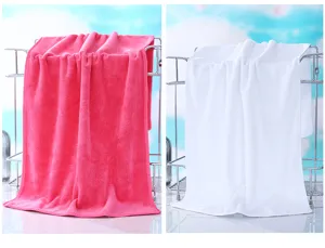 Detailed view of soft microfiber absorbent towels in pink and white hanging on metal rack.