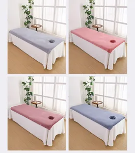 Detailed view of thick microfiber massage bed cover with face hole, soft spa table linen.