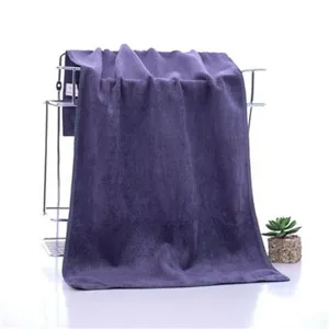 Thickened absorbent purple bath towel detail, soft textile fabric for hotel and salon use.