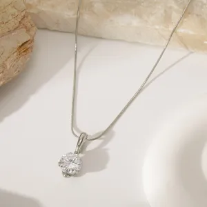 Detail shot of a minimalist round diamond pendant snake chain necklace with elegant minimalist style.