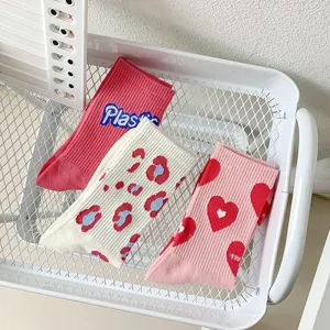 Close-up of cute sweet style mid-tube socks in a white basket featuring lovely prints.